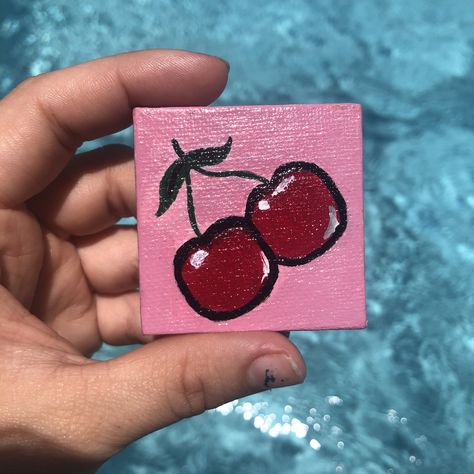 2”x2” mini canvas painting of the cutest cherries 🍒 this mini canvas comes included with the purchase of the original Cherry Bomb canvas painting. #minicanvas #minicanvasideas #minicanvaspainting #minicanvasart #acrylicpainting #acrylicart #dormartwork #dormdecor #bedroomart #bedroomdecor #bedroomwallart Cute Mini Art Easy, 2x2 Canvas Paintings Easy, Mini Canvas Art 2x2, 2x2 Painting Ideas, 4x4 Canvas Ideas Easy, Tiny Paintings Simple Easy, Tiny Canvas Art Easy, Cherry Painting Aesthetic, Basic Canvas Painting