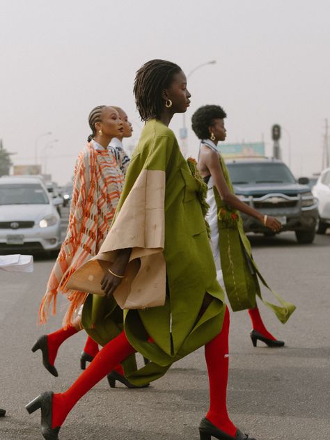 Inspired by traditional Nigerian attire, NKWO’s Cactus Agbada fuses time-honored craft and modern glamor. It’s made from the prestigious Aso-oke fabric—woven on hand-operated looms with a contrasting side panel—and has a feminine V-neck, wide sleeves, and a dramatic asymmetric hem. Playful embellishments and interesting textures lend the look a bohemian feel. Take cues from the brand and style yours with a crisp white shirt and platform sandals. - V-neck, wide sleeves, asymmetric hem, raffia app Nigerian Street Style, Nigerian Street Fashion, Traditional Nigerian Clothing, Nigeria Aesthetic, Nigeria Art, Nigerian Attire, Nigeria Clothes, Garden Editorial, African Street Style