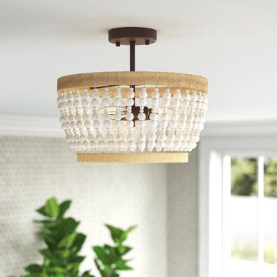 Add some boho flair to your entryway or hallway with this 3-light semi-flush mount. It features a rustic iron frame that's accented with natural rope designs in a light brown hue, and it's draped in weathered-white wooden beads for a coastal feel we love. This flush mount has an open candelabra inside that aims ambient light all around your space from three 40W bulbs, which are sold separately. Plus, this piece works well with a dimmer switch to create the lighting you want. Rated for dry locati Ceiling Hugger Light Fixture, Beachy Flush Mount Lighting, Semi Flush Hallway Lighting, Natural Flush Mount Light, Coastal Semi Flush Mount Lighting, Semi Flush Entryway Lighting, Coastal Entryway Lighting, Coastal Kitchen Lighting Fixtures, Coastal Flush Mount Lighting