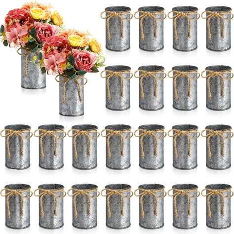 PRICES MAY VARY. Ample Quantity for Multiple Uses: this set of 24 rustic vases for home decor comes with the classic iron color; With a substantial quantity and beautifully paired twine bows, these vases can cater to your different decorative needs elevating the overall atmosphere of your space Compact yet Spectacular: each galvanized vase fills a space of approximately 2.76 x 4.33 inches/ 7 x 11 cm, a proper size to fit in any corner of your room; These vases may be small but when filled with f Engagement Party Food Table, Farmhouse Vases Decor, Simple Table Centerpieces, Flowers For Table, Country Wedding Centerpieces, Rustic Birthday Parties, 50th Birthday Centerpieces, Adult Birthday Decorations, Dollar Tree Wedding