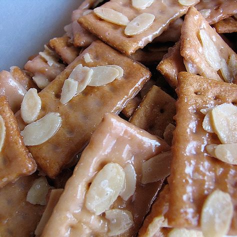 Almond Crackers  Sprinkle sliced almonds over. Mix butter (2 sticks) and sugar (2/3c) in saucepan. Cook just until it comes to a boil and stirring constantly. Quickly spread butter mixture over all crackers. Bake at 350 degrees for 10 minutes. Quickly remove from pan and place on foil to cool. Almond Crackers Recipe, Almond Crackers, Graham Cracker Butter, Cracker Candy, Club Crackers, Cream Corn, Cracker Toffee, Crackers Recipe, Wine Press