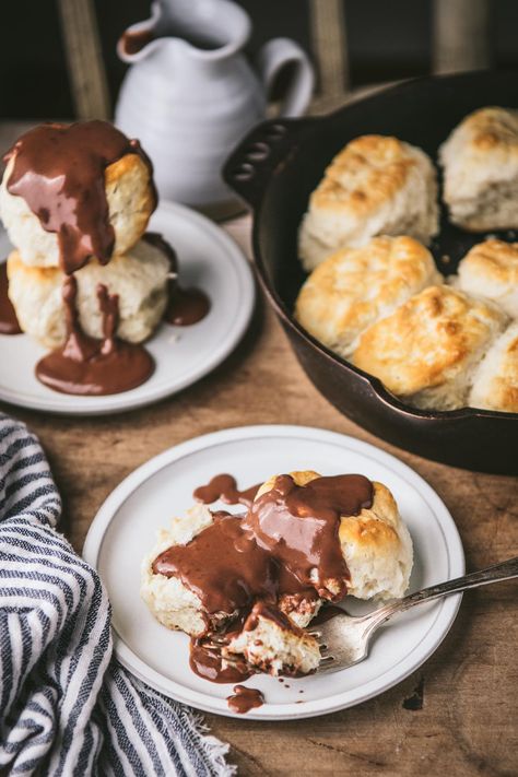 Chocolate gravy is a classic Southern treat! Served over warm buttermilk biscuits for breakfast, or drizzled on pound cake and ice cream for dessert, this easy recipe has been delighting both kids and adults for generations. Best of all, it only requires a handful of basic ingredients that you probably already have in your kitchen -- and it's ready in about 15 minutes! Chocolate And Biscuits Recipe, Biscuits And Chocolate Gravy, Easy Chocolate Gravy Recipe, Buiscits And Gravy Recipes, Southern Biscuits And Gravy, Chocolate Gravy Recipe, Biscuits For Breakfast, Southern Buttermilk Biscuits, Chocolate Gravy