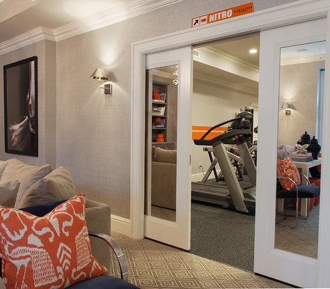 Mirrored pocket doors open to a basement workout room filled with exercise equipment. Workout Room Design, Basement Workout Room, Basement Home Gym, Workout Room Home, Piscina Interior, Basement Gym, Basement Inspiration, Workout Room, Diy Basement