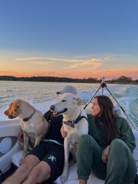 Two dogs and two humans sitting on a boat watching the sunset Family Dogs Aesthetic, Boating On Lake, Family With Dog Aesthetic, Family Dog Aesthetic, Family Boat Day, Family On Boat, Big Dog Aesthetic, Boat Ride Aesthetic, Big Family Aesthetic