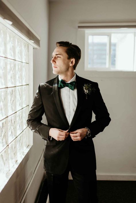 Elegant groom style with a classic black suit, evergreen boutonniere and emerald green bow tie | Image by Laurken Kendall Emerald Green Bow Tie, Black Evergreen, Downtown Minneapolis, Green Bow Tie, Minneapolis Wedding, Winter Vibes, Green Tie, Black Suit, Junebug Weddings