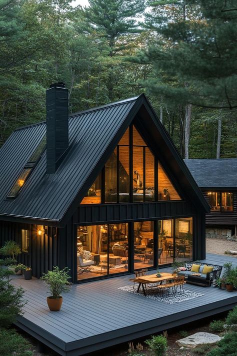 Modern black a frame house with black board and batten siding black metal roof with chimney a gambrel with window on the roof side large glass. Check out all of these stunning and chic dark A-frame houses that pack a ton of charm into a small forest retreat.