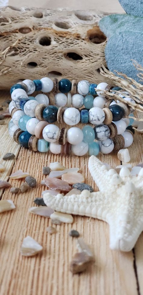 "Free Gift! Free Shipping! I Will Ship Within 24 Hours! Three Handmade Beach and Boho Bracelets.   A beautiful combination of 8mm Natural Apatite Gemstone, 8mm White Howlite beads, 8mm Blue Rondelle Faceted Glass beads, 8mm Heishi Sea Shells, 8mm Coconut Heishi beads, 4x6mm Chrysocolla Rondelle beads, and Blue Shells.  A high-quality elastic stretch cord is used to string the beads together.  Size: Each bracelet is suitable for a wrist circumference of about 6.6\" Final Touch: Your bracelet will be delivered in a Burlap Gift Bag. Please visit my store for many other colorful bracelets! I can customize any of my listings to your liking! https://www.etsy.com/shop/TitiTataStore/ To Measure your wrist: take a piece of string and wrap it comfortably around your wrist and mark. Hold against a ru Heishi Bead Jewelry Ideas, Shell Bead Bracelet, Sea Shell Bracelet, Boho Bracelets Stack, Burlap Gift Bags, Beach Jewelry Boho, Style Birthday, Bracelets Ideas, Mens Bracelets