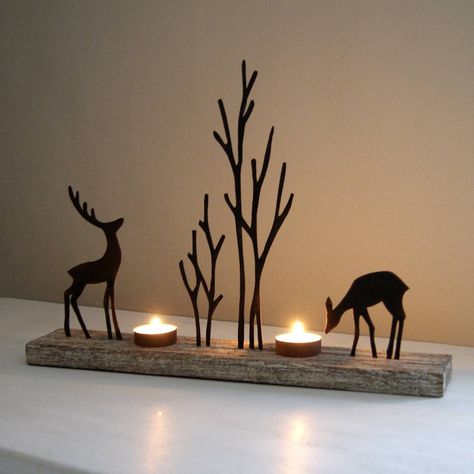 Charming seasonal tealight holder.Enchanting tealight holder with reindeer silhouettes in a woodland scene in rusty finish on a lime wood base. Quite stunning on mantle pieces and side tables as the silhouettes of the reindeer once the tealights are lit create wonderful shadows on the wall behind or just as lovely placed on a window sill as a welcoming glow for visitors.Metal and wood.28cm H x 40cm L x 7cm D Ren Geyiği, Reindeer Silhouette, Silhouette Christmas, Woodland Scene, Creation Deco, God Jul, Scroll Saw Patterns, Tealight Holder, Christmas Wood