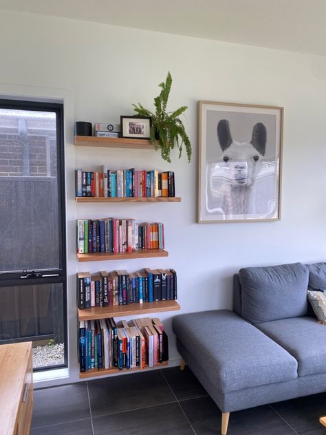 DIY floating bookshelf made from Tasmanian Oak Floating Book Shelf Ikea, Floating Book Bookshelf, Book Shelves Over Couch, Floating Bookshelf Living Room, Shelf Next To Couch, Behind The Couch Bookshelf, Books Above Couch, Under Tv Bookshelf, Bookshelf Wall Apartment