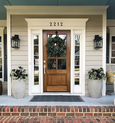 Haven’t worked on the front porch since December but when it’s March and 60 degrees...you get to it! Spring, we’re ready for you! Front Door With Lanterns, Front Door Tudor Home, Decorate With Shutters Inside, Front Door With Shutters On Each Side, Wood Front Door Brick House, Farmhouse Style Front Door, Front Door Farmhouse Entrance, Front Door Ideas Wood, Front Door With Porch