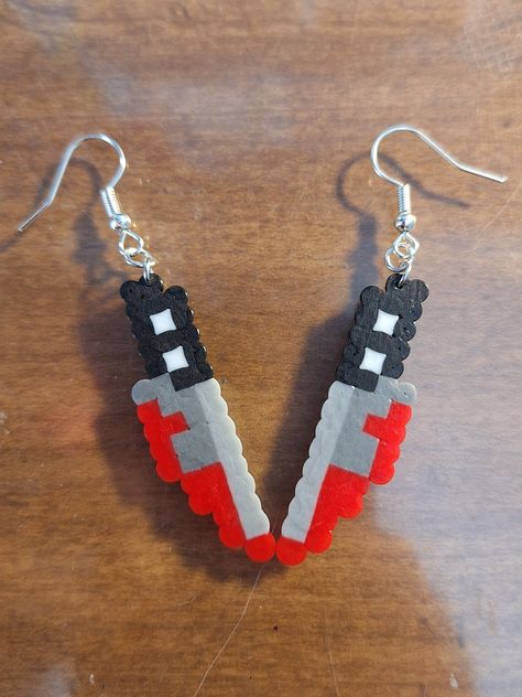 a pair of bloody knife earrings for the spooky lovers to enjoy Perler Bead Knife Earrings, Motley Crue Perler Beads, Monster Perler Beads, Perler Bead Halloween Ideas, Peeler Beads Patterns Halloween, Small Perler Beads Ideas Halloween, Fuse Beads Designs, Ramen Perler Beads, Knife Perler Bead Patterns