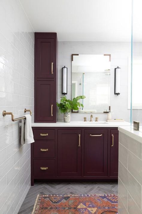 Aubergine painted washstands with brass pulls topped with a white quartz countertop and a brass faucet. Maroon Bathroom, Aubergine Paint, Burgundy Bathroom, White Vessel Sink, Herringbone Wood Floor, Purple Bathrooms, Herringbone Floor, White Quartz Countertop, Wood Vanity