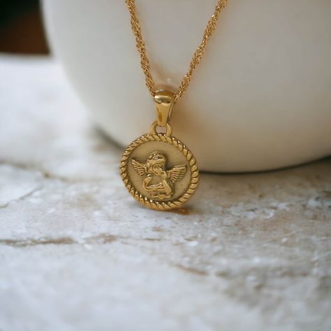 Embrace cosmic protection with our cherubic Gold Angel Necklace. This celestial pendant features an etched guardian angel design plated in lustrous 18k gold. This meaningful angel necklace makes a thoughtful gift for sending uplifting vibes. * N E C K L A C E ∙ D E T A I L S * › Material: Gold plated stainless steel › Length: 40cm chain, 5cm extender › Pendant: Length 17mm, Height 20mm › Non-tarnish, Waterproof, Hypoallergenic M O R E ∙ F R O M ∙ U S ♡ https://www.etsy.com/uk/shop/MysticJeweller Celestial Pendant, Guardian Angel Necklace, Angel Pendant Necklace, Angel Design, Gold Angel, Angel Necklace, Angel Pendant, Celestial Jewelry, Engraved Necklace