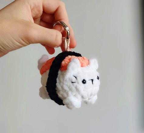 Here is my adorable Sushi Kitty, a small and charming companion for all cat and sushi lovers! ❤️ 🍣 Custom-made to order. Each order is handmade, ensuring that you always receive a unique product 🤲 The Sushi Kitty is available with or without a keychain, allowing our customers to choose their preferred style. Whether you want to attach it to your bag, backpack, or simply keep it as a standalone plush, the choice is yours! This versatile item makes for an ideal gift, whether for yourself or someone special. Surprise your loved ones with this unique fusion of cats and sushi that will bring joy and a touch of whimsy to their lives. Sushi Cat Crochet, Crochet Sushi Keychain, Cat Keychain Crochet, Sushi Crochet, Crochet Sushi, Sushi Plush, Sushi Cat, Cat Amigurumi, Cat Keychain