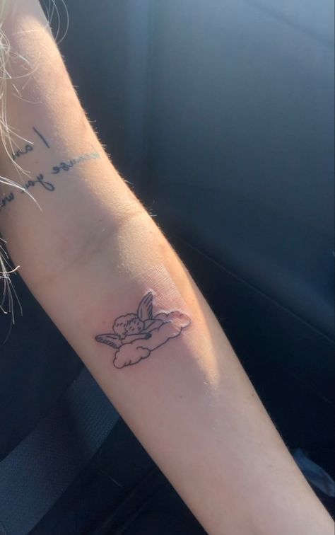 Fine Like Angel Tattoo, Angel Tattoo For Women Minimalist, Cherub Tattoo Placement, Cherub Arm Tattoo, Cherub Tattoo Meaning, Cloud Angel Tattoo, Cherub Cloud Tattoo, Hyper Feminine Tattoo, Cherub Angel Tattoo Simple