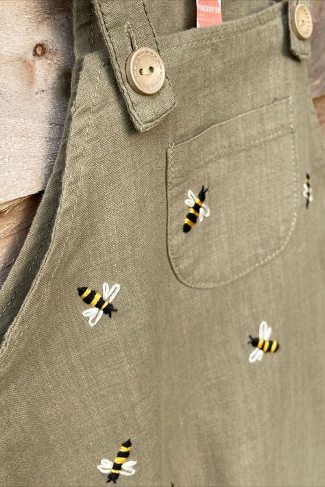 Who agrees that the only thing cuter than little linen dungarees are little linen dungarees with hand embroidered bees? 🐝 They also happen to be a clue for something exciting coming soon… keep an eye out! Shop hand embroidered, sustainable, upcycled adult and children's clothing as well as embroidery hoop decor and PDF patterns on Etsy: https://www.etsy.com/uk/shop/Pincushionembroidery Linen Dungarees, Embroidered Baby Clothes, Hoop Decor, Embroidery Jeans Diy, Embroidery Hoop Decor, Minimal Shirt Design, Baby Overall, Bee Embroidery, Baby Sewing Projects