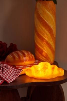 Add a tasty treat to your space with this croissant light. The portable light is battery-powered for use in whichever space you need, complete with a pastry design. **Content + Care** \- Plastic \- Wipe clean \- Requires 3 x AAA batteries (not included) | Urban Outfitters Croissant Lamp - Orange Pastry Design, Orange Fits, Bread Loaf, Cool Lamps, Batteries Not Included, Aaa Batteries, Portable Light, Loaf Bread, Croissant