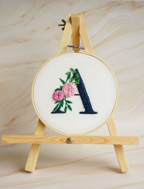 This personalized embroidery "A" letter design is hand stitched on quality cotton and neatly set into a bamboo hoop. - Handmade item. - Hoop diameter: 7 inch. - Shipping in USA. Please include the custom Initial (letter) you would like embroidered in the Personalization Box at checkout. heck out more embroidery designs in my shop: http://www.etsy.com/shop/SaliArtBoutique Let’s connect on Instagram @saliartboutique A Letter Design, Hoop Cross Stitch, Hand Embroidery Letters, Flowers Name, Name Decor, Calligraphy Art Print, Stitch Flowers, Name Embroidery, Floral Embroidery Patterns