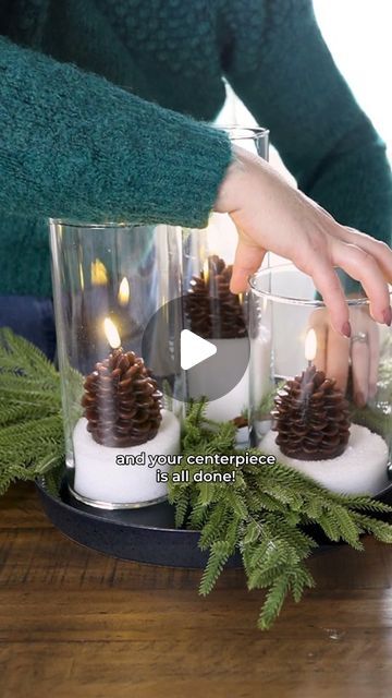 Christina Dennis on Instagram: "✨Cozy Centerpiece Idea✨ The IKEA cylinder vases are the perfect starting point for a gorgeous & sparkling centerpiece. Simply fill them with Epsom salt, add an Amazon faux pinecone candle to each one, and style on a tray with faux greenery and twinkle lights. The candles and greenery are linked in the Christmas list in my Amazon shops; link in my bi0! 🩷 Would you make this?

#thediymommy #ikeahack #centerpiece #christmasdecor #amazonfinds" Pinecones In Vase, Pinecone Candle, Pinecone Centerpiece, Cylinder Lights, Pine Cone Candles, Simply Filling, Faux Greenery, Cylinder Vase, Epsom Salt