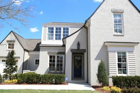 Sherwin-Williams,  body of the home is Amazing Gray SW 7044 in satin finish, the exterior trim/columns/trim are Shoji White SW 7042.  The cedar timber lintels above the windows are Porpoise SW 7046. Amazing Gray, Exclusive Invitation, Painted Brick Exteriors, Best Exterior Paint, Painted Brick House, Shoji White, Stucco Exterior, Exterior Renovation, Grey Exterior