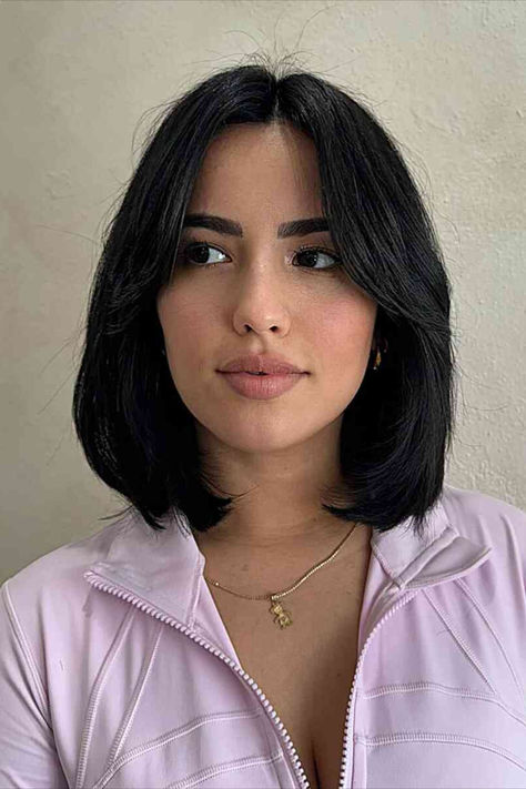 Sophisticated woman with a longer bob and middle-parted bangs Lived In Bob Haircuts, Short Bob On Long Face, Haircuts In Style, Middle Bob Hairstyles, Black Bob With Curtain Bangs, Lob Haircut Black Hair, Short Hair Above Shoulder Straight, Layered Bob Middle Part, Middle Part Bob With Layers