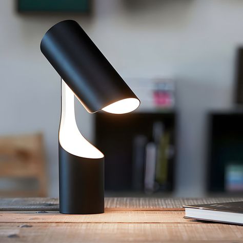 The Black Table Lamp is a model of minimalist design. Its black finish gives it a modern look, and the glossy white interior revealed when the lampshade is lifted adds an interesting contrast of color and texture. The lamp stands freely, its columnar shape demonstrating the harmony of geometry and utility. A switch on the cord allows for easy operation.   This desk lamp is 8.7'' Diameter wide, 13.4'' Height, and weighs only 4.41lb.The base and body, both cylindrical, ensure stability and present Black Desk Lamp, Metal Desk, Steel Lighting, Metal Desks, Small Table Lamp, Black Desk, Black Table Lamps, Form Design, Led Desk Lamp