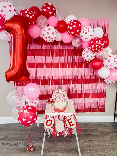 Feb First Birthday Ideas, One Year Old Valentine Birthday Party, Valentine’s Day First Birthday Cake, Valentine Birthday Decorations, Love Theme First Birthday, Heart Warrior First Birthday Party, Heart Themed 1st Birthday Party, Valentines First Birthday Photo Shoot, First Birthday Themes Valentines