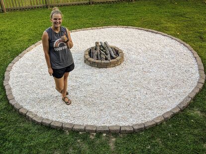 We bought our house almost 6 years ago and let’s just say, the backyard needed some love. There were some overgrown flower beds and a pretty sad excuse for a fire pit that the previous owners had left behind. We moved into our house in the fall and by early spring, we had already replaced the sad, dilapidated looking brick circle “fire pit” for a much nicer kit that we found at Lowe’s. I wish I could say that once we upgraded the fire pit ring and the stones that we used it all… Fire Pit With Gravel, Sand Fire Pits, Backyard Firepit Area, Outdoor Fire Pit Area, Fire Pit Seating Area, Fire Pit Landscaping, Fire Pit Ring, Simple Garden, Round Fire Pit