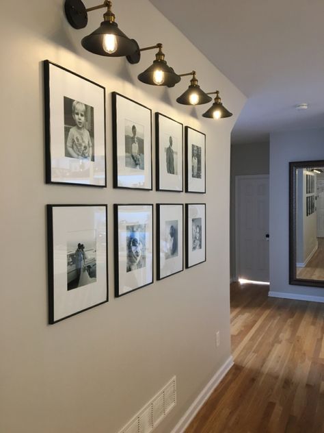 Scone Light Over Pictures, Horizontal Photo Wall, Hallway Picture Display With Light, Sconces Picture Wall, Hallway Portrait Wall, Vertical Photo Wall Display, Horizontal And Vertical Picture Wall, Living Room Portrait Wall Ideas, Gallery Hallway Ideas