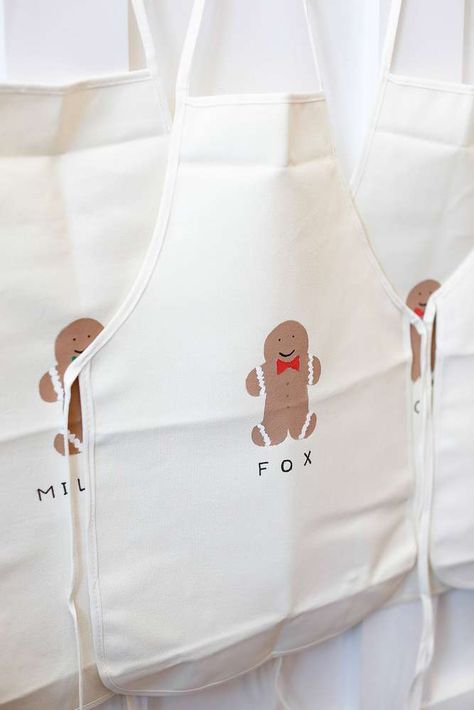 Gingerbread aprons at a woodland Christmas birthday party! See more party planning ideas at CatchMyParty.com! Ginger Bread Birthday Party Theme, Christmas Themed Kids Birthday Party, Gingerbread Man Party Decorations, Gingerbread Kids Party, Gingerbread Man Theme Party, Xmas Birthday Party Ideas, Christmas Cookie Birthday Party, Gingerbread Birthday Party Ideas, Gingerbread Theme Birthday Party