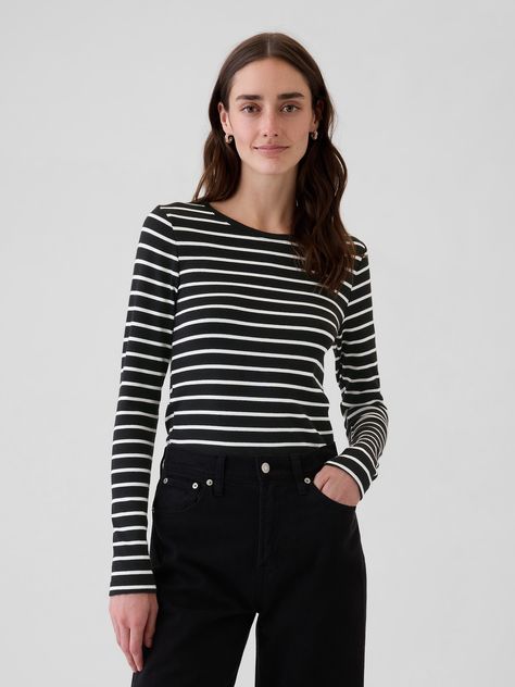 Soft knit stretch cotton and modal t-shirt.  Crewneck.  Long sleeves.  Straight silhouette with a loose fit.  Hits at the hip.  Models wearing Gap White Striped Shirt Outfit, Black Striped Shirt, 2023 Outfits, Stripped Tops, Costume Inspo, White Stripes Shirt, Autumn 2024, Stripe Shirt, Striped Tee