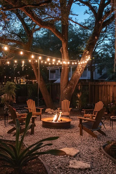 backyard firepits ideas for seating areas with pea gravel, chairs and string lights Fire Pit Pea Gravel, Gravel Seating Area, Seating Area Ideas, Fire Pit Yard, Backyard Firepit Area, Outdoor Fire Pit Seating, Outdoor Fire Pit Area, Pea Gravel Patio, Backyard Upgrades