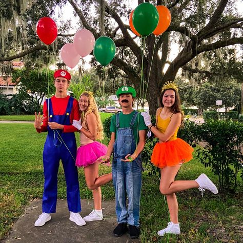 Princess Daisy And Princess Peach Costumes, Mario Crew Costumes, Super Mario And Princess Peach Costumes, Mario Luigi Princess Peach Costume Trio, Mario And Daisy Costume, Super Mario Daisy Costume, Diy Mario And Peach Costumes, Luigi And Daisy Halloween Costume, Princess Peach And Daisy Diy Costume