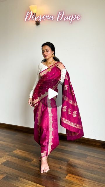 𝐀𝐫𝐜𝐡𝐞𝐞 | Saree Drapes on Instagram: "Devsena Saree Look from Bahubali | Save and send this easy saree tutorial to a saree lover 🌸

Pure silk saree of the day- is a katan banarasi in dual tone of plum and pink. I believe it is the saree that actually enhanced the look of the drape.

How to wear saree in Devsena Style-
🌸 Choose weightless and easy drape pure silk saree fabrics like katan silk, mulberry silk, mysore silk.
🌸 Pick Kanjivaram, Kanchipuram, satin silk and tussar silk if they’re longer than 5.5m.
🌸 Pick a contrasting blouse design so your saree highlights well. Refer to pinterest for blouse design ideas.
🌸 Follow the above tutorial, keep pinning every time you pleat the saree to easily undo it whenever required.
🌸 Accessories with temple jewellery, go for chain jhumki, Devsena Saree Draping Tutorial, Styling Banarasi Saree, Devsena Saree Draping, Devsena Look, Banarasi Saree Draping Styles, Saree Jewellery Style, Silk Saree Blouse Styles, Wedding Looks Indian Sister, Satin Saree Look