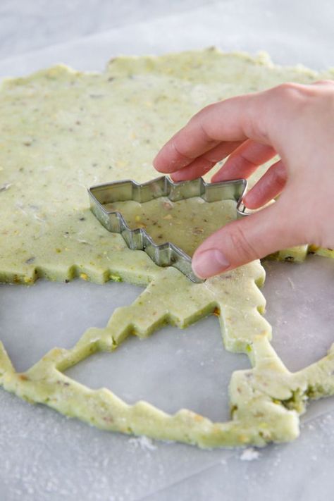 Dec 22, 2020 - Holiday baking season is upon us, and these pistachio-flavored cutout cookies are the perfect canvas for holiday decoration. These incredibly soft, subtly green sugar cookies are flecked with bits of chopped pistachios and decorated with Butter Pecan Roll Out Cookies, Rolled Christmas Cookies Recipes, Pistachio Cut Out Cookies, Rolled Out Cookies, Pistachio Sugar Cookies, Flavored Roll Out Cookies, Flavored Sugar Cookies Cut Outs, Sugar Cookie Variations, Pistachio Christmas Cookies