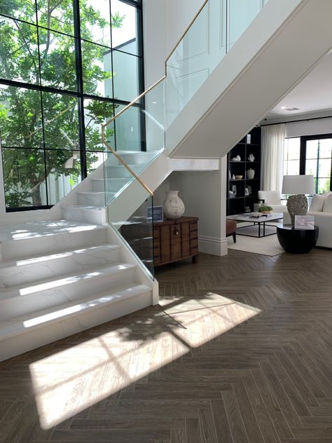 Exactly the stair design we like. Wall panneling on their stairs and the same windows. Glass Balustrade with Brass trim Glass Balustrade Stairs, Stairs Background, Luxury Basement, Big Glass Windows, Wall Stairs, Glass Stair, White Staircase, Stair Design, Marble Staircase