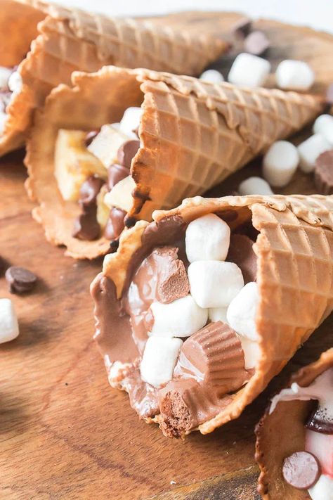 These Waffle Cone Smores are a fun treat any time of year. A summer twist on a fall treat or a fall twist on a summer treat – You decide! These Waffle Cone Smores are a delicious treat whichever way you cook them, but let's be honest - it's most fun to cook on the grill! Waffle Cone Smores, Cone Smores, Campfire Cones, Waffle Cone, Waffle Cones, Fall Treats, Fun Treats, Treat You, Cooking On The Grill