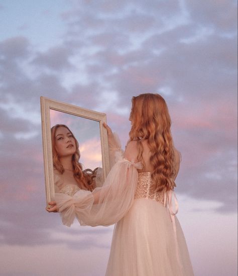 Princess wearing a dreamy dress holds a mirror up to the sunset sky.  Girl with red hair wearing a cream dress looks at her reflection in a dreamy whimsical Photoshoot. Fairytale Theme Photoshoot, Whimsical Editorial Fashion Photography, Dreamy Beach Photography, Fairytale Studio Photoshoot, Pink Fairy Photoshoot, Art Inspired Photoshoot, Mystical Photoshoot Ideas, Fairytale Photoshoot Princesses, Whimsical Beach Photoshoot