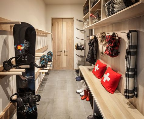 This mudroom (or winter sport storage space) is perfectly designed with light wood cabinets, racks and hooks. A wood bench makes it easy to take off boots, and upper storage spaces with wire baskets keep things organized. Ski Mudroom, Outdoor Gear Storage, Ski House Decor, Gear Room, Ski Room, Sports Storage, Ski Cabin, Light Wood Cabinets, Mudroom Entryway