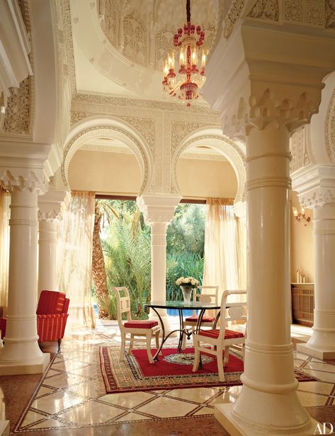 With exposed wood beams, textured walls, and a 17th-century Italian walnut front door, this foyer is composed of traditional Mediterranean elements. The Malibu beach house was devised by architect Douglas Burdge and the owner of the home, designer Richard Shapiro. The sculptural staircase is a modern contrast to the 19th-century replica of an ancient Greek statue at its base. Greek Bedroom, Mediterranean Room, Mediterranean Furniture, Mediterranean Home Interior, Rustic Mediterranean, Mediterranean Interior Design, Mediterranean Mansion, Mediterranean Aesthetic, Greek Decor