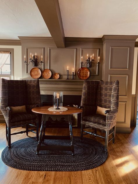 Obsessed with the shape of the chairs. Table, 2 small chairs near kitchen area. Colonial Keeping Room, Moody Colonial Living Room, Salt Box House Interior, Colonial Fireplace Ideas, Brown Wainscoting, Pennsylvania Gothic, American Colonial Living Room, Colonial Farmhouse Interior Design, Fireplace Wainscoting