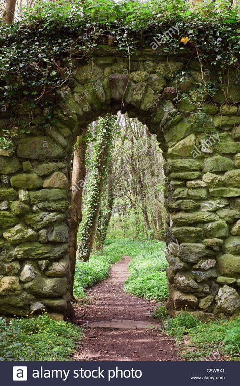 Download this stock image: Stone wall arch over a garden path leading into woodland. UK - C5W6X1 from Alamy's library of millions of high resolution stock photos, illustrations and vectors. Owencore Aesthetic, Castle Archway, Anglesey Wales, Wall Arch, Stone Walls Garden, Stone Archway, Lost Garden, Landscaping Retaining Walls, Stone Stairs