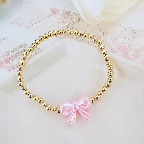 Gorgeous 14k Gold Plated 4mm Beaded Bracelet With A Pink Pearl Bow Bead Perfect Bracelet To Wear Alone Or Stacked With Other Favorite Pieces Bracelet Measures Approximately 7 Inches This Is For One Bracelet Only Tags: Preppy, Coquette, Pearls, Pink Bow, Spring Fashion, Gift For Her, Easter, Trend, Trendy, Love Shack Fancy, Stoney Clover Lane, Enewton, Mean Girls,