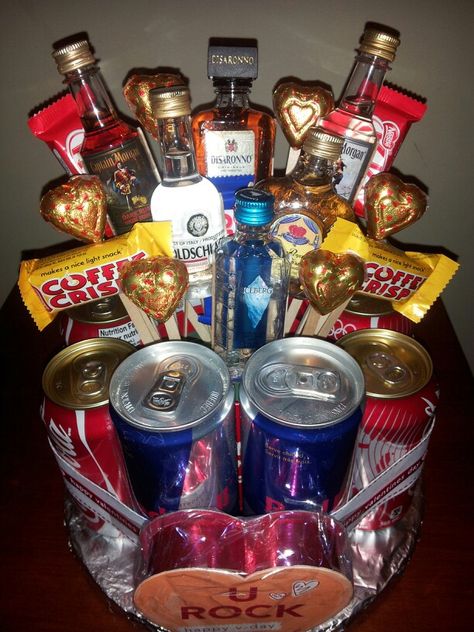 Men's Valentines Candy and Liquor Bouquet Cake featuring six mini bottles, Red Bull,  Coca Cola and chocolate treats.   For more information, visit us on Facebook!   Facebook.com/MemorablySweetArrangementsandGifts Homemade Baskets, Adult Gift Basket, Wine Bouquet, Liquor Bouquet, Man Bouquet, Silent Auction Baskets, Bouquet Cake, Candy Creations, Valentines Candy