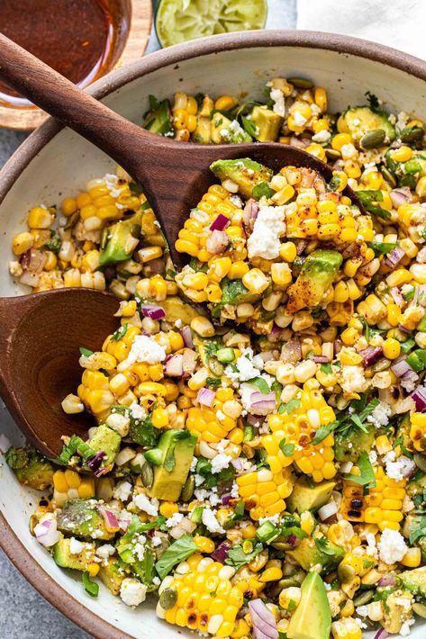 This avocado corn salad is a summer salad made with grilled corn, chunks of avocado, cilantro, queso fresco, pepitas, and a honey lime vinaigrette. Avocado Corn Salad, Chili Lime Vinaigrette, Honey Lime Vinaigrette, Corn Tomato Salad, Avocado Snack, Honey Chipotle Chicken, Potluck Salad, Corn Avocado Salad, Cucumber Avocado Salad