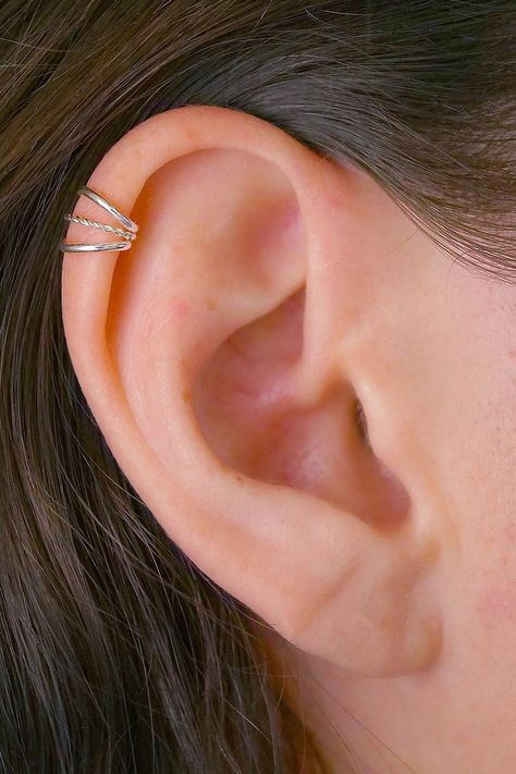 An amazingly pretty new Cartilage Ear Cuff. It features three delicate bands, the middle band is twisted. This piece requires no piercing and sits comfortably on the high ear and simulates a helix piercing. This Ear Cuff is available in these high quality metals: Sterling Silver 14K Gold Filled Rose Gold Filled Two Tone Oxidized Silver  This piece will arrive in a pretty Gift Box and include simple fitting instructions. Perfect for gift giving 3rd Ear Lobe Piercing, Upper Ear Percinings, Helix Piercing Cuff, Helix Cuff Piercing, Midi Helix Piercing, Silver Helix Piercing, Upper Ear Piercing Stud, Middle Helix Piercing, High Helix Piercing