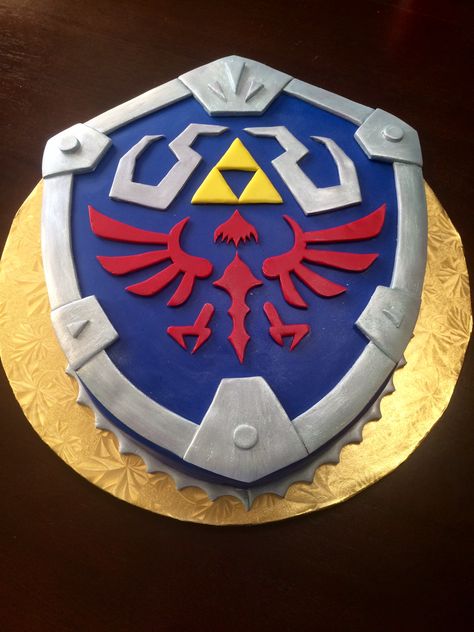 Hylian Shield groom's cake from Legends of Zelda made out of chocolate cake! #GroomsCake #Wedding #ChocolateCake #Zelda #HylianSheild #TheHungryHood Legends Of Zelda, Zelda Cake, Zelda Party, Zelda Wedding, Hylian Shield, Dragon Cakes, Recipes Using Bananas, Zelda Birthday, Cake Wrecks