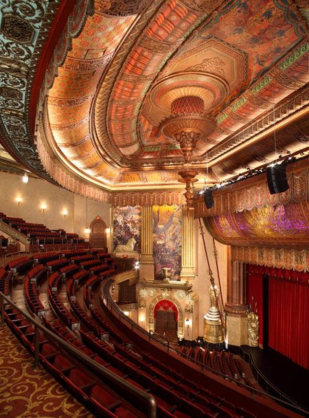 Interior of the Beacon Theater. The ornate neo-Grecian interior features 30 ft-tall  Greek goddesses flanking its curtainless stage, which  rises from its basement. White marble floors and mahogany bars on the orchestra and mezzanine levels. Exquisite detailing include elaborate gilded plaster moldings, polished hardwood, and brass staircase rails. Corridor murals depict Eastern scenes of trading caravans. With its superior acoustics it is a leading venue for concerts Broadway Theatre New York, Concert Venues, New York Theater, Historic Theater, Majestic Theatre, Theatre Interior, Bonnie Raitt, Bb King, James Taylor