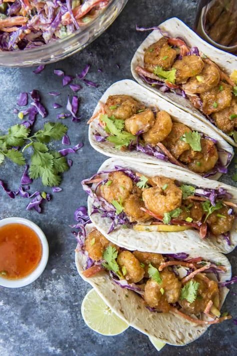 These Bang Bang Shrimp Tacos are where the appetizer meets dinner! Crispy, spicy copycat Bang Bang Shrimp get all wrapped up in your favorite tortillas with a sweet and tangy coconut mango slaw for a flavor explosion that's ready to devour in less than an hour. Coconut Coleslaw, Mango Shrimp Tacos, Bang Bang Shrimp Tacos, Mango Slaw, Spicy Seafood, Shrimp Taco, Shrimp Taco Recipes, Bang Bang Shrimp, Crispy Shrimp