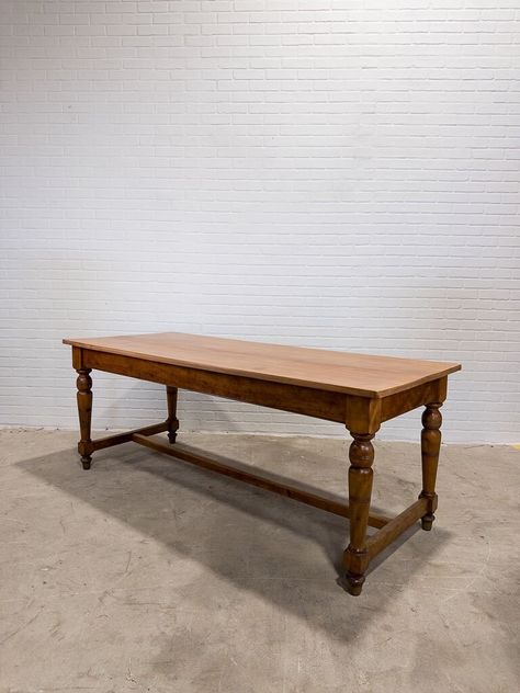 With beautifully turned legs and a newly restored surface, this antique table is ready for its new home.  Dimensions: L: 72"  W: 29.37"  H: 28.25"  Apron: 22.75" from floor Note- this table is lower than typical. Please make sure the floor to apron height will work for you prior to ordering. Please note: Signs of wear are considered proof of age. Scratches, chips, dents, cracks, signs of historical repair, replaced hardware and uneven coloring are all very common with antique furniture. We do our best to represent each piece well so there are no surprises upon arrival. If you have questions about an item or would like additional photos prior to purchasing, we will be happy to accommodate.  Shipping: To help keep shipping costs down, we bundle orders and ship to each region regularly. We sh Antique Trestle Table, Antique Work Bench, Ukrainian Dishes, Antique Work Table, Butcher Table, French Farmhouse Dining Table, Bakers Table, Traverse City Mi, Trestle Table